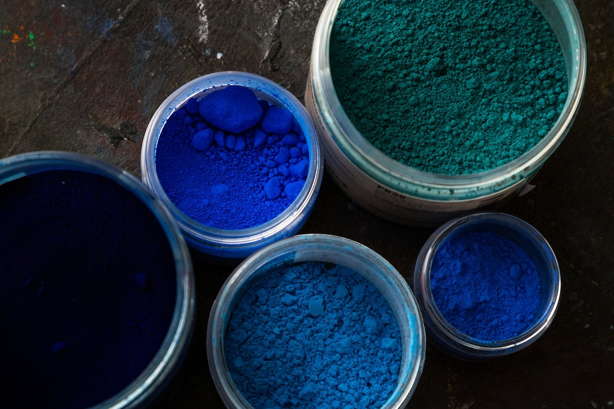 Paint cans showing deep blue color from phthalocyanine pigments