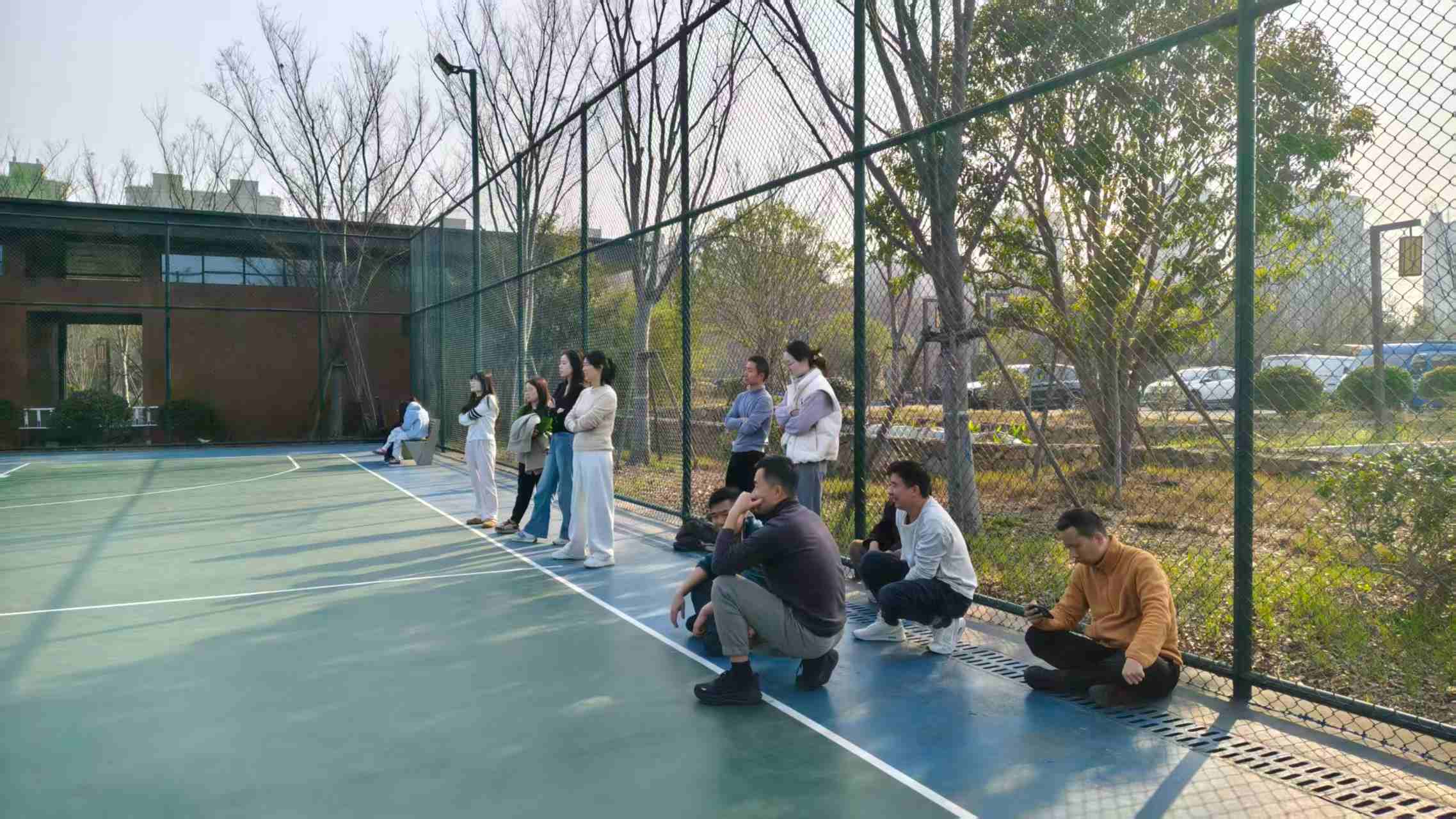 Fineland Chem team badminton activity with colleagues playing friendly matches outside the office 3