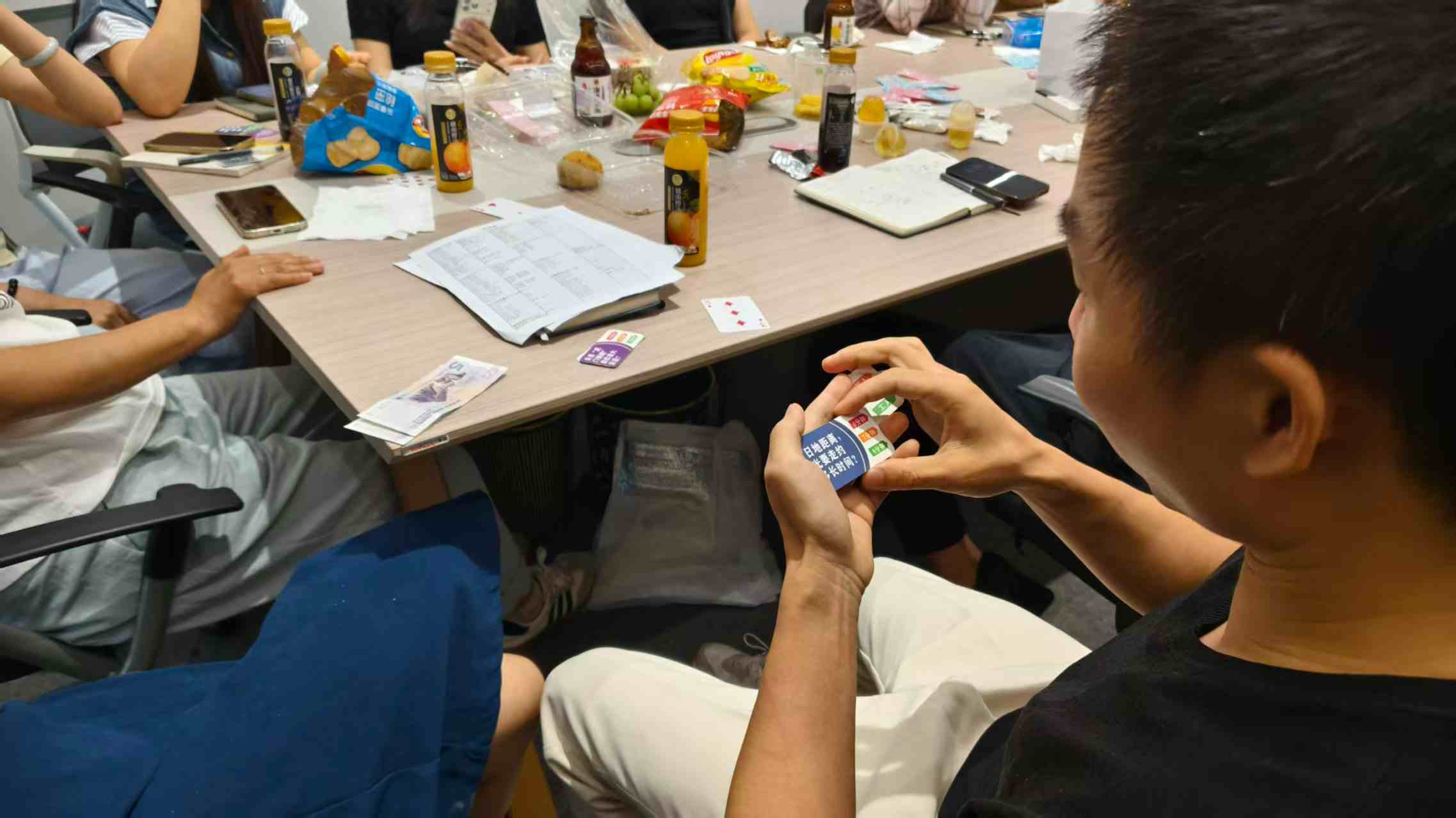 David reading a quiz card and asking a question during a team trivia game at Fineland Chem