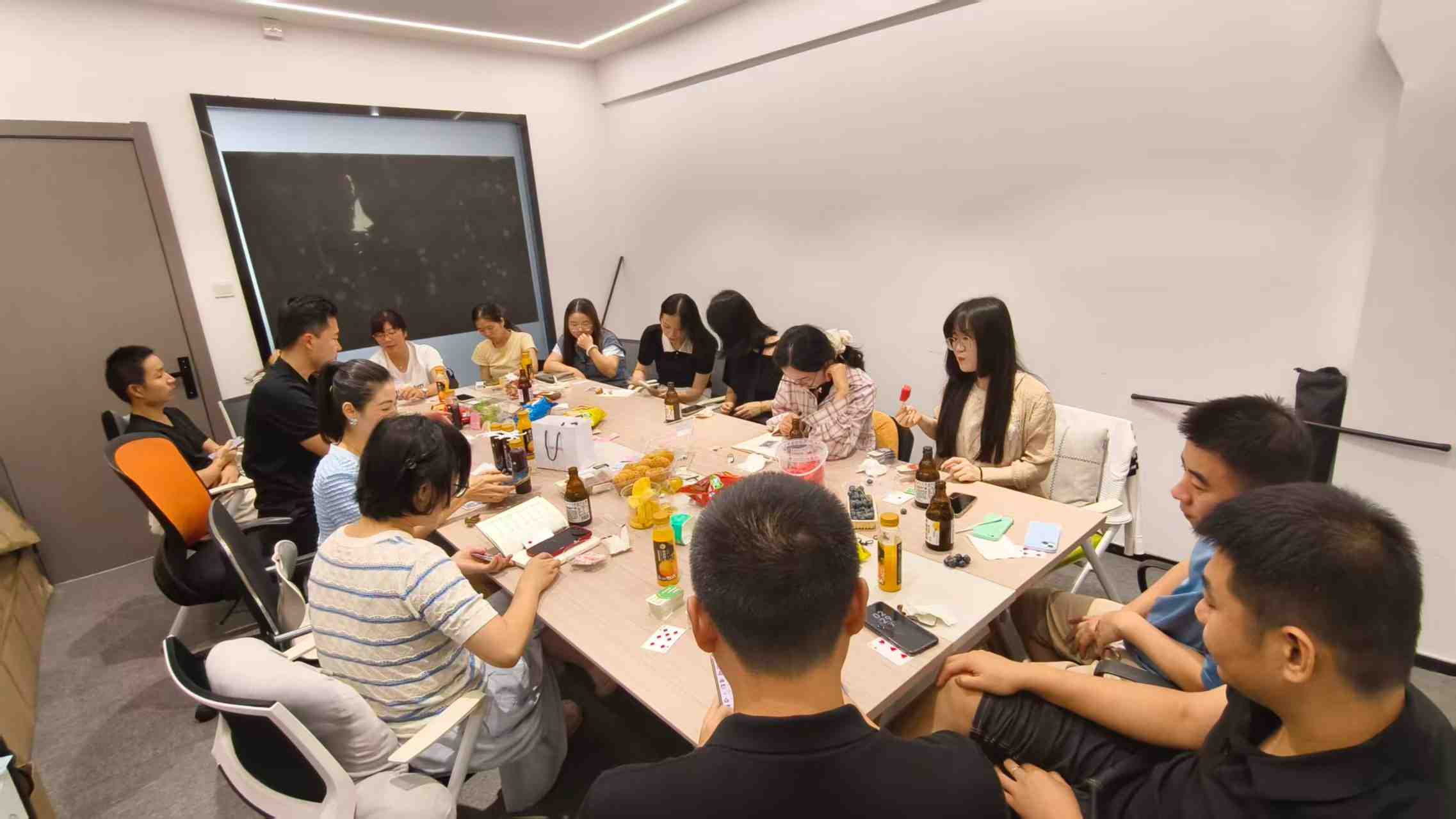 Team members enjoying food, drinks, and conversations during Fineland Chem's company tea party